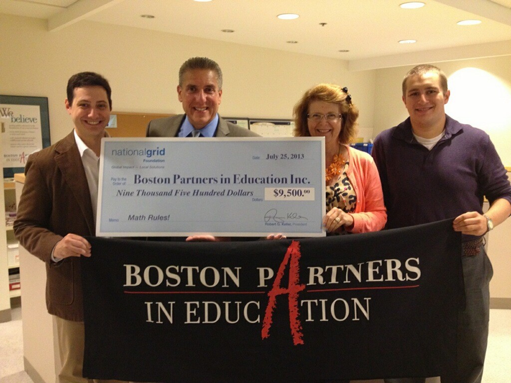 The National Grid Foundation President Robert Keller presents a check to Boston Partners staff