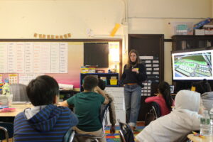 Sarah Cunningham infront of a third and sixth grade class at Edison k-8 for a Pathfinders visit